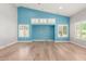 Vaulted ceiling living room with wood floors and blue accent wall at 10913 N 153Rd Ln, Surprise, AZ 85379