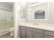 Modern bathroom with gray vanity, quartz countertop, and walk-in shower at 10913 N 153Rd Ln, Surprise, AZ 85379