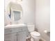 Simple bathroom with gray vanity and round mirror at 10913 N 153Rd Ln, Surprise, AZ 85379