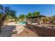 Inviting kidney-shaped pool with surrounding patio and pergola at 10913 N 153Rd Ln, Surprise, AZ 85379