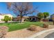 House exterior with mature tree and artificial turf at 10913 N 153Rd Ln, Surprise, AZ 85379
