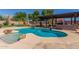 Inviting kidney-shaped pool with a pergola and outdoor kitchen at 10913 N 153Rd Ln, Surprise, AZ 85379