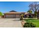 Two-story house with three-car garage and landscaped lawn at 10913 N 153Rd Ln, Surprise, AZ 85379