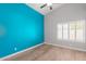 Bright bedroom with wood flooring and an accent wall at 10913 N 153Rd Ln, Surprise, AZ 85379