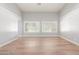 Living room with large windows and wood floors at 10913 N 153Rd Ln, Surprise, AZ 85379