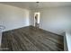 Bedroom with wood-look floors and access to another room at 4908 W Ocotillo Rd, Glendale, AZ 85301