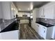 Modern kitchen with white cabinets and black countertops at 4908 W Ocotillo Rd, Glendale, AZ 85301