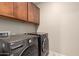 Laundry room with LG washer and dryer, and wood cabinets at 15229 W Moreland St, Goodyear, AZ 85338