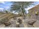 Cozy fire pit area with seating and desert landscaping at 10793 E La Junta Rd, Scottsdale, AZ 85255
