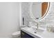 Modern powder room with white stone tile and a sleek vanity at 10793 E La Junta Rd, Scottsdale, AZ 85255