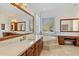 Elegant bathroom with a soaking tub and dual vanities at 10793 E La Junta Rd, Scottsdale, AZ 85255