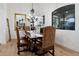 Formal dining room with a rustic wooden table and leather chairs at 10793 E La Junta Rd, Scottsdale, AZ 85255