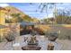 Inviting fire pit with comfortable seating, surrounded by desert plants at 10793 E La Junta Rd, Scottsdale, AZ 85255