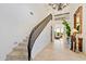 Elegant staircase with wrought iron railing and tile flooring at 10793 E La Junta Rd, Scottsdale, AZ 85255