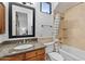 Updated bathroom with granite vanity, bathtub, and shower at 10793 E La Junta Rd, Scottsdale, AZ 85255