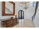 Grand entryway with a sweeping staircase and large chandelier at 10793 E La Junta Rd, Scottsdale, AZ 85255