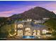 Luxury home with a pool and mountain backdrop at sunset at 10793 E La Junta Rd, Scottsdale, AZ 85255