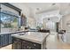 Open kitchen with a large island, custom cabinetry, and views into the Gathering room at 10793 E La Junta Rd, Scottsdale, AZ 85255