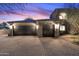 Two-car garage with paver driveway and exterior lighting at 10793 E La Junta Rd, Scottsdale, AZ 85255