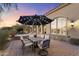 Outdoor patio with seating area, umbrella, and adjacent spa at 10793 E La Junta Rd, Scottsdale, AZ 85255