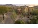 Exterior of a luxurious home with stone accents and mountain views at 10793 E La Junta Rd, Scottsdale, AZ 85255