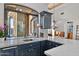 Kitchen wet bar with granite countertop and wine glass storage at 10793 E La Junta Rd, Scottsdale, AZ 85255