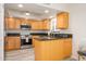 Modern kitchen with island and stainless steel appliances at 12212 N Paradise Village S Pkwy # 451, Phoenix, AZ 85032