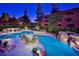 Attractive lighted pool area at night with multiple pools and waterfalls at 12212 N Paradise Village S Pkwy # 451, Phoenix, AZ 85032