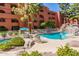 Community pool with multiple lounge chairs and umbrellas at 12212 N Paradise Village S Pkwy # 451, Phoenix, AZ 85032