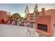 Outdoor patio area with fireplace and pool view at 12212 N Paradise Village S Pkwy # 451, Phoenix, AZ 85032