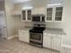 Kitchen with granite countertops, stainless steel appliances, and white cabinets at 20117 N Portico Way, Surprise, AZ 85387