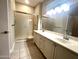 Bathroom boasts double sinks, a shower, and an updated vanity at 20117 N Portico Way, Surprise, AZ 85387