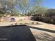 Landscaped backyard with a flagstone patio and decorative accents at 20117 N Portico Way, Surprise, AZ 85387