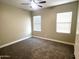 Well-lit bedroom featuring neutral wall paint and carpet at 20117 N Portico Way, Surprise, AZ 85387