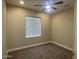 Spacious bedroom with neutral carpeting and ceiling fan at 20117 N Portico Way, Surprise, AZ 85387