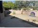 Landscaped backyard with a flagstone patio and decorative accents at 20117 N Portico Way, Surprise, AZ 85387