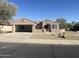 One-story home with two-car garage and desert landscaping at 20117 N Portico Way, Surprise, AZ 85387