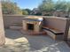 Outdoor patio with a built-in fireplace and seating at 20117 N Portico Way, Surprise, AZ 85387
