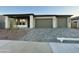 Modern house exterior with three-car garage and landscaped front yard at 22861 E Alyssa Rd, Queen Creek, AZ 85142