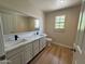 Double vanity bathroom with quartz countertops and wood-look flooring at 2158 N Yale --, Mesa, AZ 85213