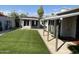 Landscaped backyard with artificial turf and covered patio at 2158 N Yale --, Mesa, AZ 85213
