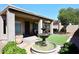 Backyard with fountain, artificial turf and covered patio at 3771 E Hazeltine Way, Chandler, AZ 85249