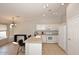 Bright kitchen featuring white cabinets, an island with seating, and a window at 3771 E Hazeltine Way, Chandler, AZ 85249