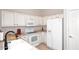 White cabinets, updated appliances, and a double sink in this well-lit kitchen at 3771 E Hazeltine Way, Chandler, AZ 85249