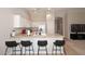 Bright kitchen features white cabinets, a breakfast bar, and modern appliances at 3771 E Hazeltine Way, Chandler, AZ 85249