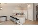 Kitchen with white cabinets, an island with seating, and tile flooring at 3771 E Hazeltine Way, Chandler, AZ 85249