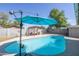 Refreshing kidney-shaped pool with patio umbrella and pergola at 124 W Hillview St, Mesa, AZ 85201