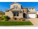 Two-story house with stone accents and a landscaped yard at 11876 W Nadine Way, Peoria, AZ 85383