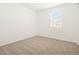Bright bedroom with neutral carpeting and window blinds at 37517 W San Clemente St, Maricopa, AZ 85138
