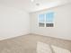 Spacious bedroom with neutral carpeting and large window at 37517 W San Clemente St, Maricopa, AZ 85138